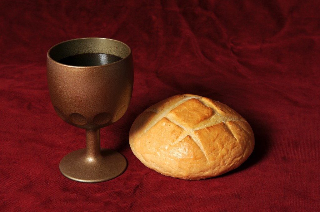 Communion elements represented by bread and wine over a red back