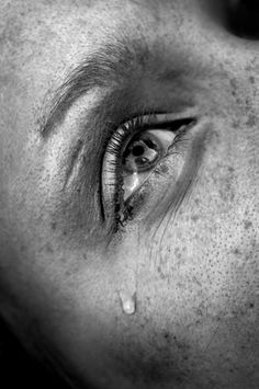 crying woman's eye, black and white image, low key, selective focus